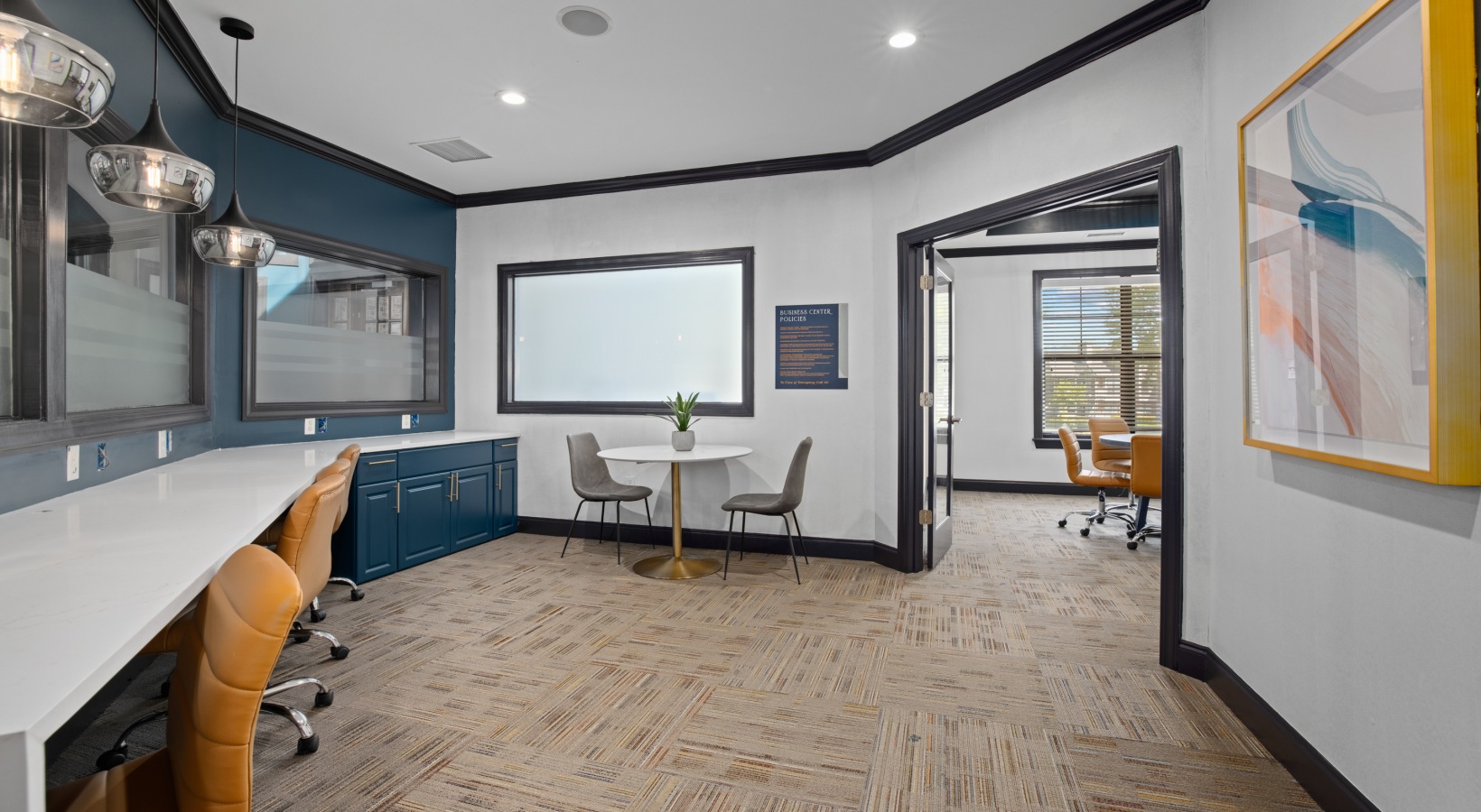 a modern office with blue walls and white cabinets at The Landon