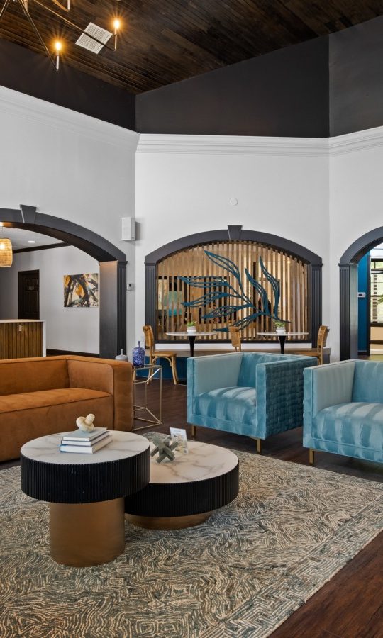 the lobby of a hotel with blue couches and chairs at The Landon
