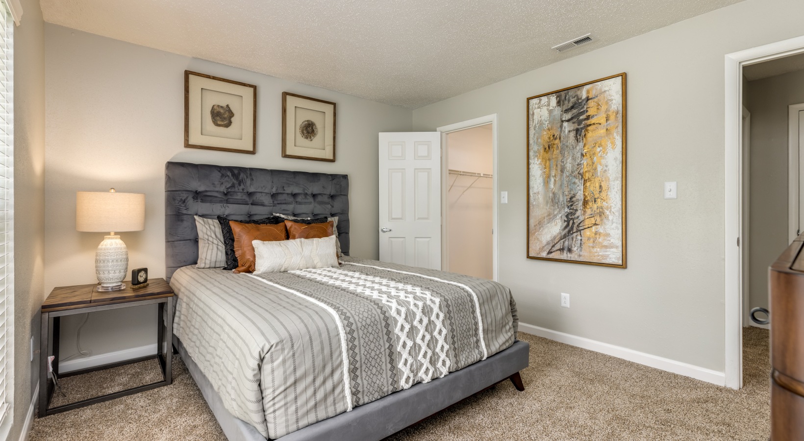 a bedroom with a bed, dresser and nightstand at The Landon