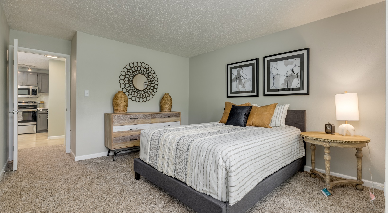a bedroom with a bed, dresser and nightstand at The Landon
