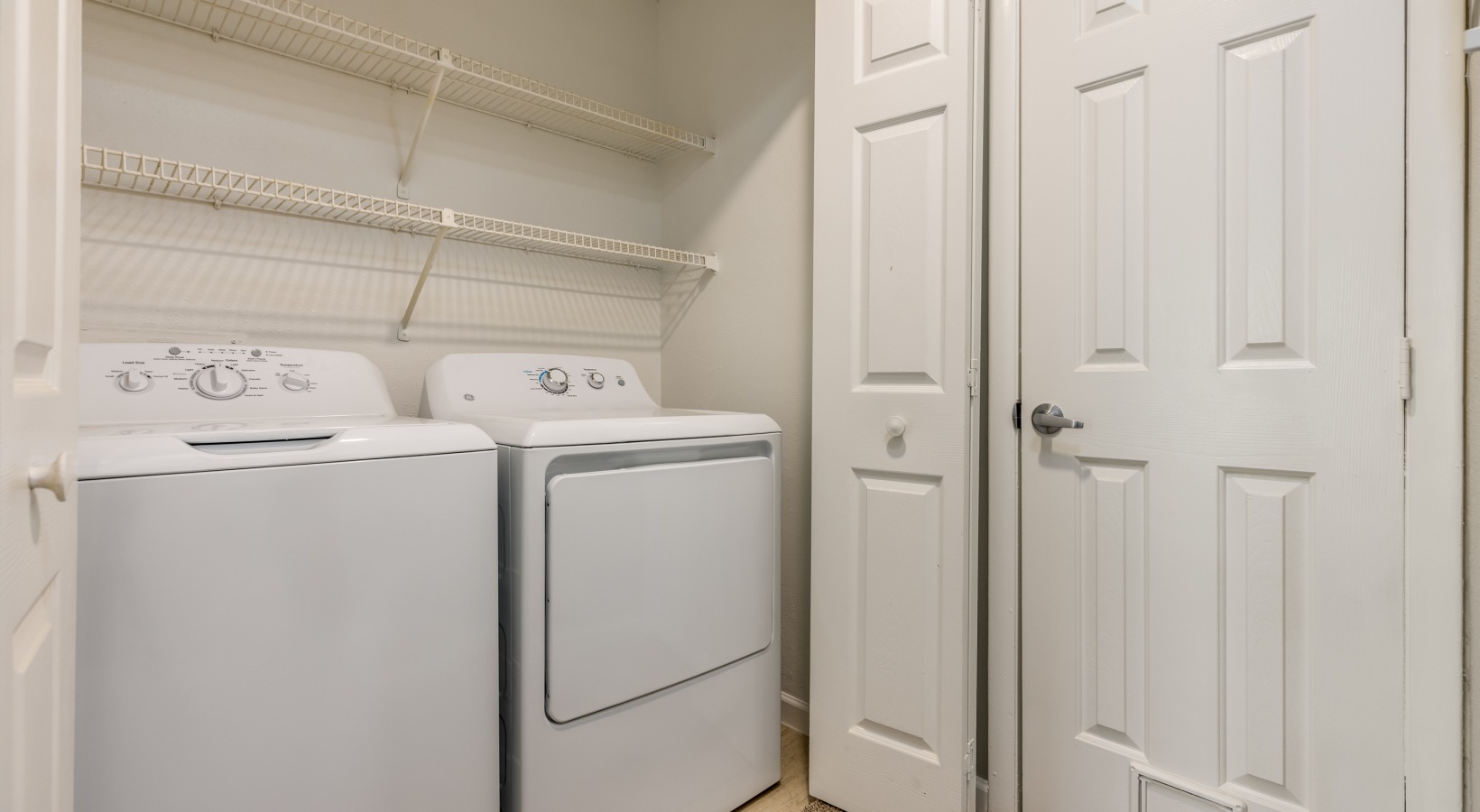 a laundry room with a washer and dryer at The Landon