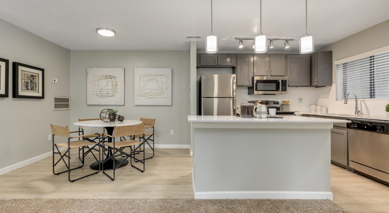 a clean and modern kitchen with stainless steel appliances at The Landon