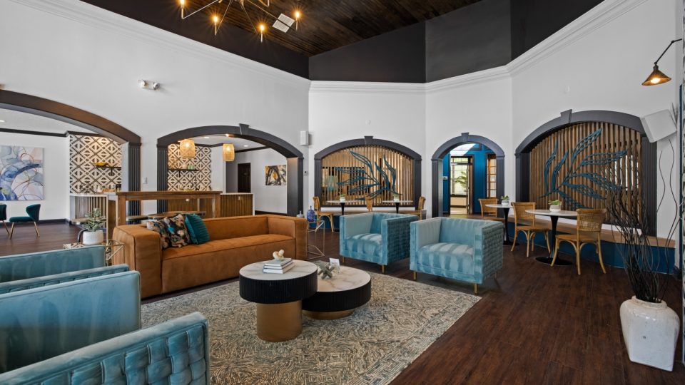 the lobby of a hotel with blue couches and chairs at The Landon